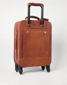 Grained calfskin suitcase Refined Brunello Cucinelli materials enrich the style of the trolley which adds an elegant and functional touch to trips. The accessory uses the texture of the grained calfskin and is equipped with two large exterior practical pockets: one in the front with a zipper closure and one in the back with a snap. A zipper closure protects the interior which has a large side zipper pocket and a spacious main compartment with an adjustable belt to secure garments while travelling. The adjustable-height telescoping handle and the double handle on the long side complete the accessory. Luxury Cognac Briefcase With Luggage Sleeve, Classic Leather Briefcase For Trips, Leather Luggage With Leather Trim For Trip, Classic Leather Luggage For Trip, Brown Leather Luggage For Business Trips, Classic Travel Cases With Leather Trim, Classic Luggage With Leather Handles For Trips, Timeless Textured Leather Briefcase For Travel, Brown Travel Bag With Grained Texture