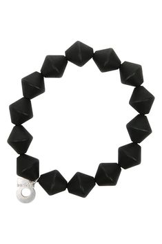 a bracelet with black beads and a silver charm