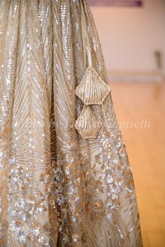 Get ready to make a statement with our Champagne Gold Sequins And Cut Dana Embroidered Lehenga Set. Made from premium fabric, it boasts stunning sequin and cutdana embroidery for a luxurious touch. Complete with a stylish ruffled dupatta and frilled hem sleeves, this ensemble is perfect for any special occasion.. Diwali Anarkali Gown With Sequins, Traditional Drape Sequin Gown For Navratri, Fitted Embellished Sequin Fabric With Traditional Drape, Traditional Sequined Anarkali Set For Receptions, Traditional Anarkali Set With Sequins For Reception, Traditional Floor-length Sequined Sharara, Embellished Embroidered Fabric For Festive Party Wear, Elegant Sequined Embroidered Fabric For Navratri, Fitted Embellished Sequin Saree Fabric