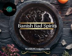 the words banish bad spirits on top of a black plate surrounded by crystals and flowers