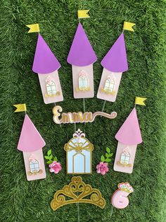 a pink and purple fairy birthday cake topper with princess castle decorations on the grass