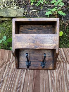 a wooden box sitting on top of a striped cloth