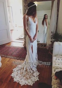 a woman standing in front of a mirror wearing a white dress