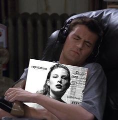 a man sleeping on a chair with a magazine covering his face