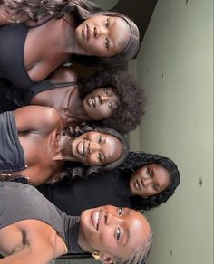 four women are standing together and smiling for the camera