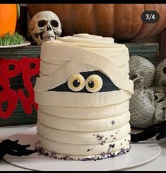 a halloween cake decorated with white frosting and eyes