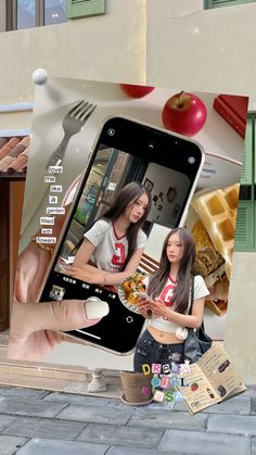 a person holding up a cell phone to take a photo with food on the screen