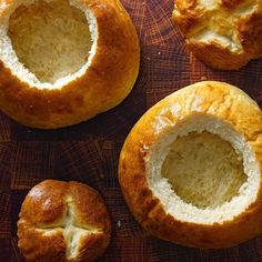 several breads are sitting on a cutting board