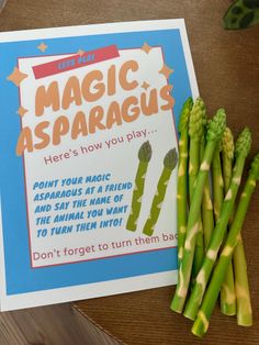 some asparagus are sitting next to a sign that says, let's learn magic