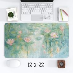 a mouse pad with water lilies on it next to a keyboard and mousepad