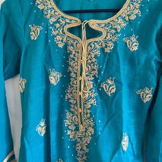 Light Weight Blue Embroidered Kurti, Brand New Never Been Worn. No Pants Or Duppata Included. Blue Kurta With Gold Embroidery For Festivals, Blue Salwar Kameez With Intricate Embroidery For Spring, Traditional Blue Kurta With Gold Embroidery, Fitted Embroidered Blue Salwar Kameez, Blue Bollywood Salwar Kameez For Summer, Blue Traditional Wear With Gold Embroidery For Diwali, Blue Sets With Gold Embroidery For Diwali, Blue Sets With Gold Embroidery For Festivals, Blue Long Sleeve Set With Gold Embroidery