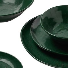 three green plates stacked on top of each other in front of a white background with black speckles