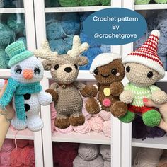 three crocheted stuffed animals sitting on top of a shelf next to each other