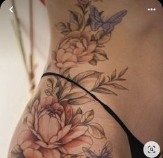 a woman's stomach with flowers and butterflies on it