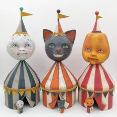 three circus clowns and one cat are standing in front of a white background,