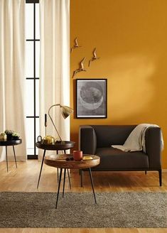 a living room with yellow walls and furniture