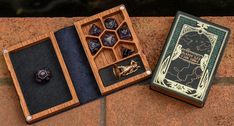 two wooden boxes with dice in them sitting on the ground