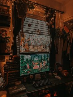 a computer screen sitting on top of a desk in front of a window covered with fairy lights