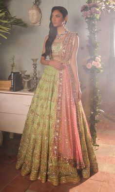 Green Lehenga and Turquoise Choli Indian Bridal Dress is a stunning attire adorned with hand-crafted details of ornaments. The shimmering details and goldwork give a glamorous touch to this perfectly stitched Bridal Lehenga Choli attire. Lehenga Choli: The choli is in an alluring turquoise color is gracefully embellished with zardosi, dabka, kundan, tilla, and goldwork. Shimmering ornaments and hanging motifs make this choli in sleeveless design, adorned with belt, a perfect choice to pair with the Bridal Lehenga. Bridal Lehenga: This Bridal Lehenga in a stunning green color is emblazoned with dabka, naqshi, mukaish, sequins, tilla, kora, Resham work, goldwork, and motifs. The Lehenga has a huge flare and is adorned with embellished borders. The Lehenga has premium net fabric. Net Dupatta: Green Embellished Traditional Wear For Reception, Embellished Green Traditional Wear For Reception, Green Embellished Floor-length Traditional Wear, Embellished Green Floor-length Traditional Wear, Pista Green Traditional Drape Gown For Reception, Green Hand Embellished Sets In Traditional Drape, Green Hand Embellished Sets With Traditional Drape, Green Anarkali Embellished Lehenga, Green Embellished Anarkali Lehenga