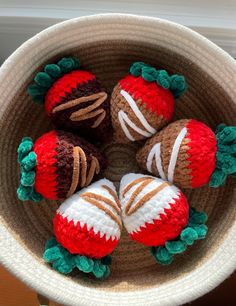 crocheted strawberries are arranged in a bowl