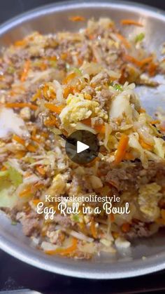 an egg roll in a bowl with carrots and celery