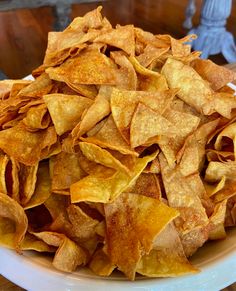 a white plate topped with chips on top of a wooden table