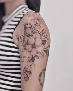 a woman's arm with flowers on it