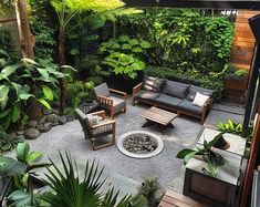 an outdoor living area with lots of plants and furniture