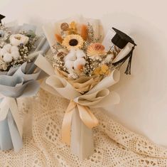 two bouquets of flowers are sitting on a lace doily next to each other