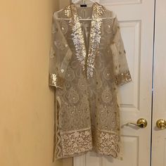 This Agha Noor Shirt Is Light Beige And Has Gold Sequins Embroidery. It Is Sheer. Size Medium. Perfect For Eid! Ships From Virginia, Us. Let Me Know If You Have Any Questions! Elegant Tunic Set With Dupatta, Festive Beige Kaftan With Resham Embroidery, Spring Wedding Kaftan With Dabka Work, Wedding Tunic Set With Zari Work, Elegant Blouse With Dupatta For Celebrations, Elegant Summer Kaftan With Dabka Work, Gold Kaftan For Summer Festivities, Gold Kaftan For Festive Summer Occasions, Gold Summer Festive Kaftan