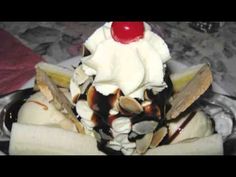 an ice cream sundae with banana slices and a cherry on top