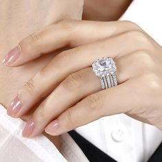 a woman's hand with a diamond ring on it