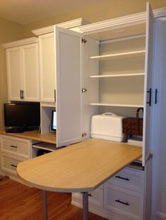 an office area with desk, cabinets and computer on the table in front of it