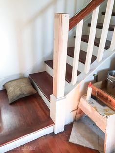 there is a dog bed under the stairs