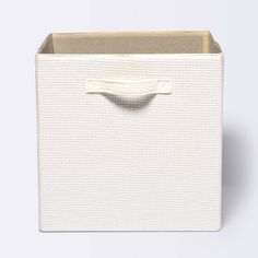 a white storage box with handles on the top and bottom, in front of a white background