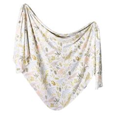 an image of a white and yellow blanket with floral print on the front, draped over it