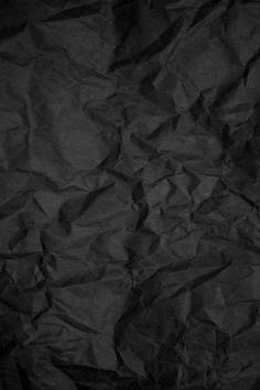 black crumpled paper background with space for text