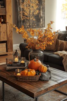 a living room filled with furniture and a coffee table covered in pumpkins on top of it