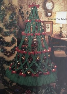 a green christmas tree with red bows and lights