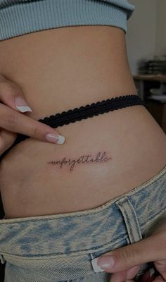 a woman's stomach with the word impossible written on it, in cursive font