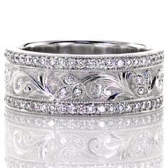 an intricate wedding band with diamonds on the inside and outside, set in 18k white gold