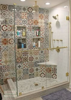 a bathroom with tiled walls and flooring in the shower area, including a stand up shower