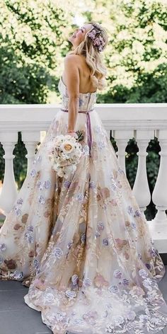 a woman in a wedding dress standing on a balcony