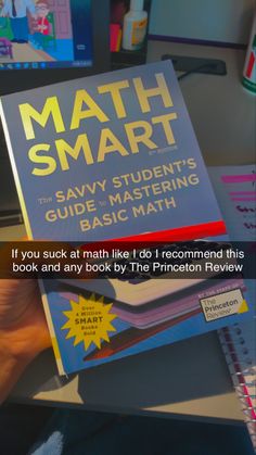 a person holding up a book with the title'math smart'in front of them