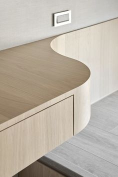 a close up of a wooden counter top on a kitchen island with an outlet in the middle