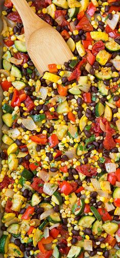 a casserole filled with black beans, zucchini, corn and tomatoes