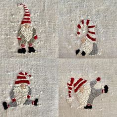 three hand embroidered gnomes on white linen with red and gray striped hats, one in the middle