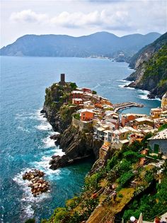 an aerial view of a village on the edge of a cliff