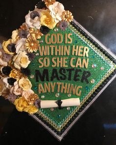 a green graduation cap with flowers on it that says, god is within her so she can master anything