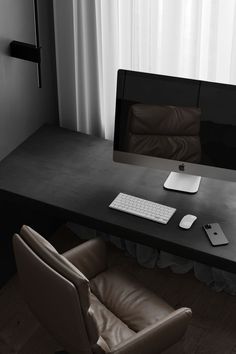 a desk with a computer, keyboard and phone on it